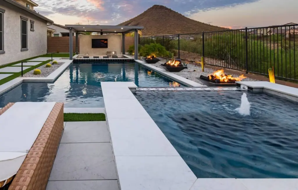Elegant backyard pool with mountain view, spa, and modern firepits.